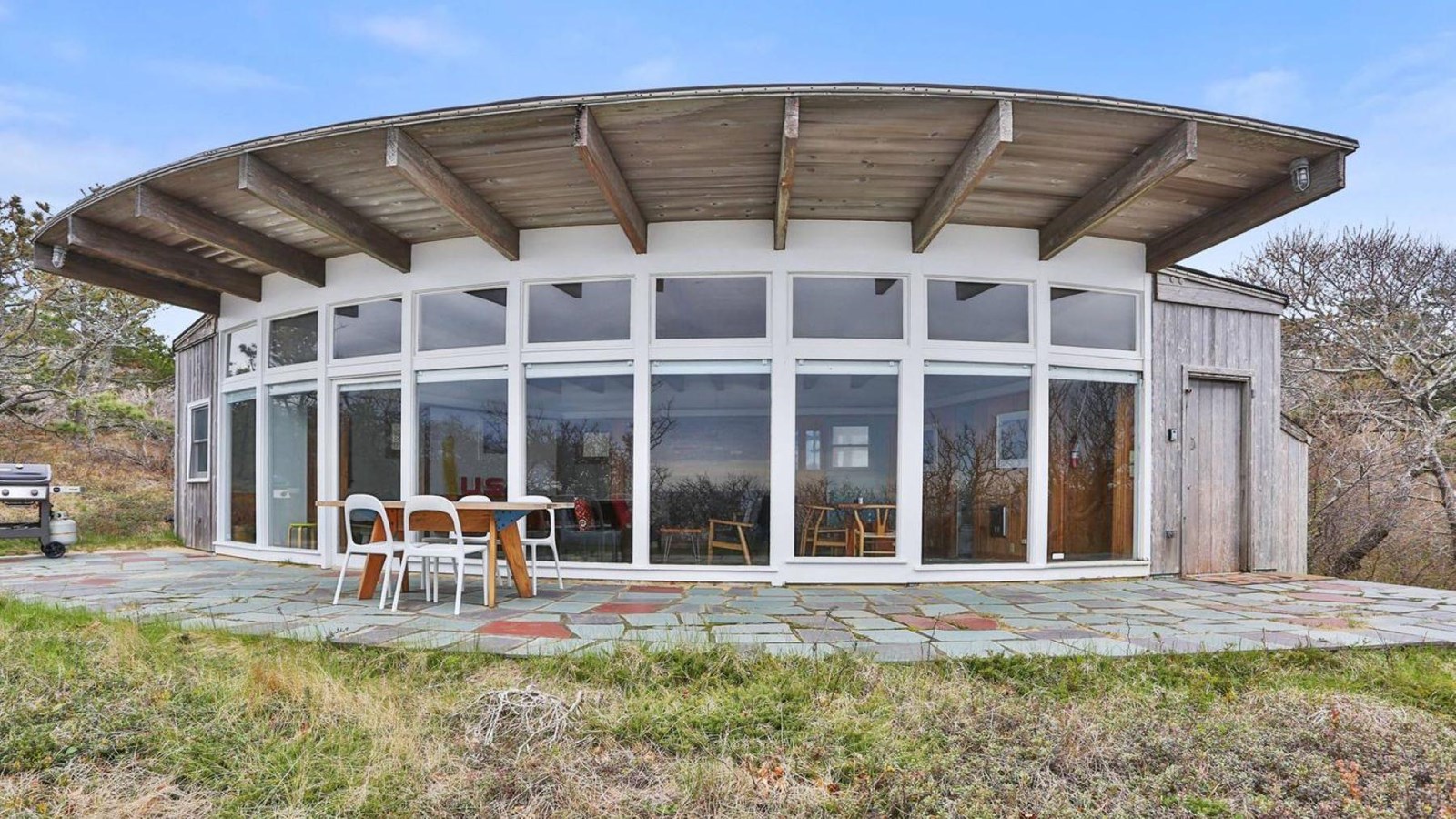 A wall of windows on the back side of the Seashore Modern House offer sweeping views of the ocean.