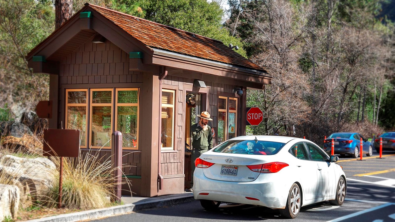 Small building with ranger in the window talking to a visitor in a vehicle