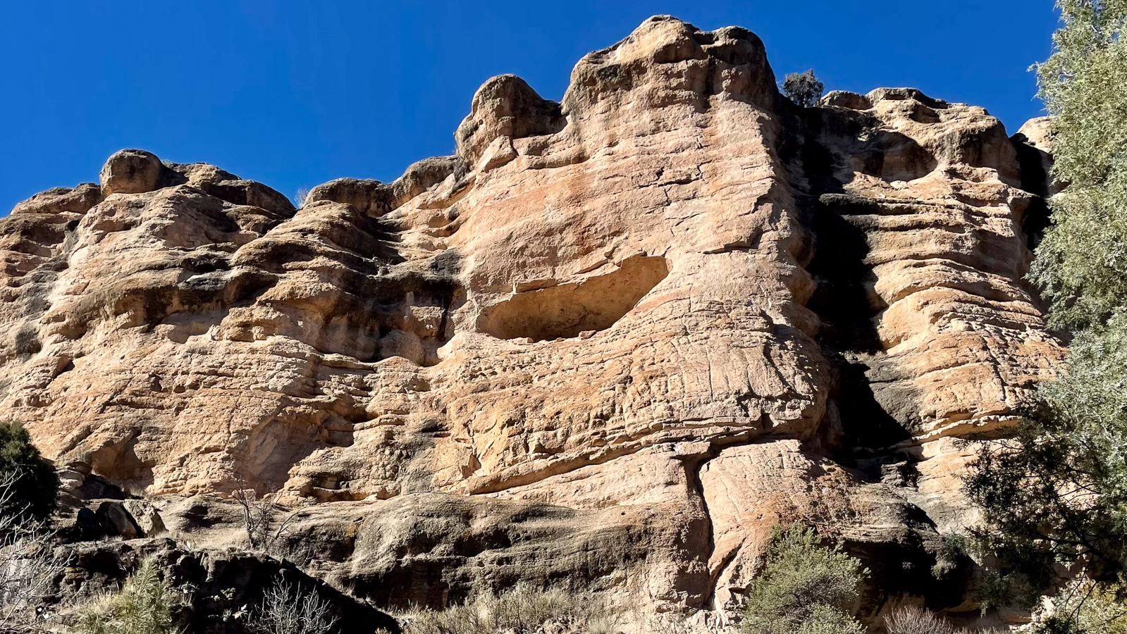Steep pink and black canyon wall.