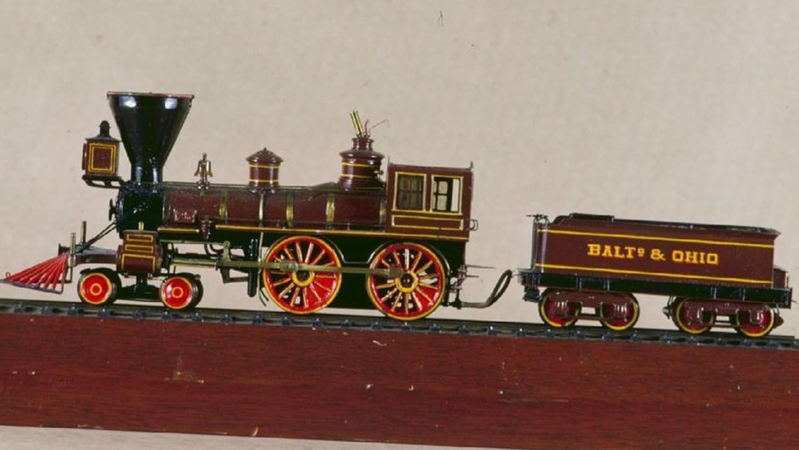 A red, black, and gold model train.