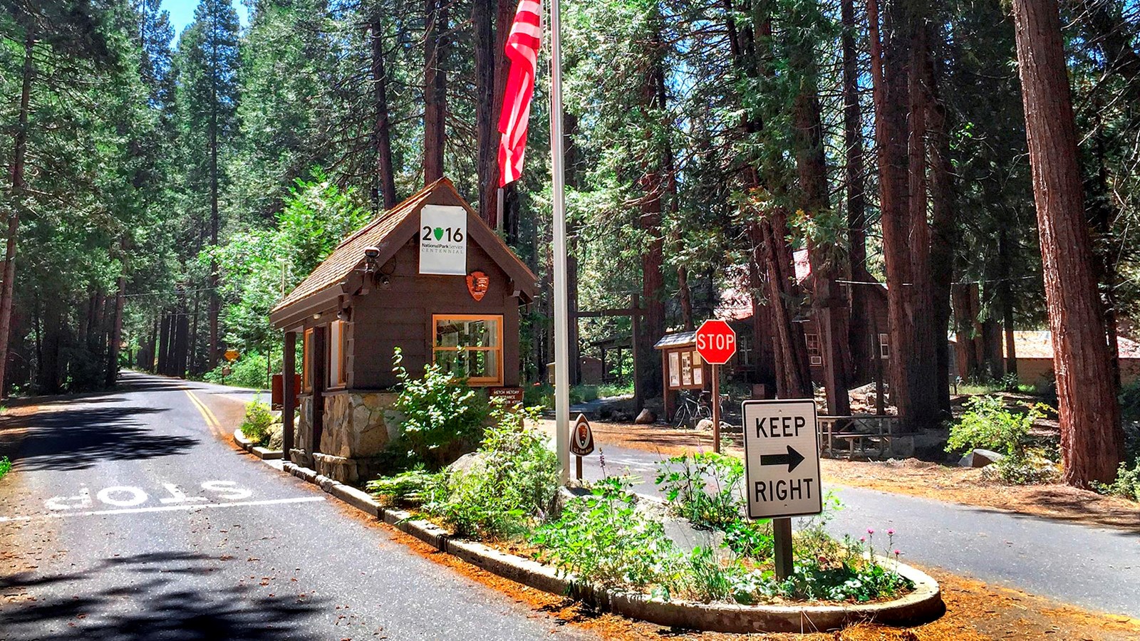 Small wooden building with American flag on pole