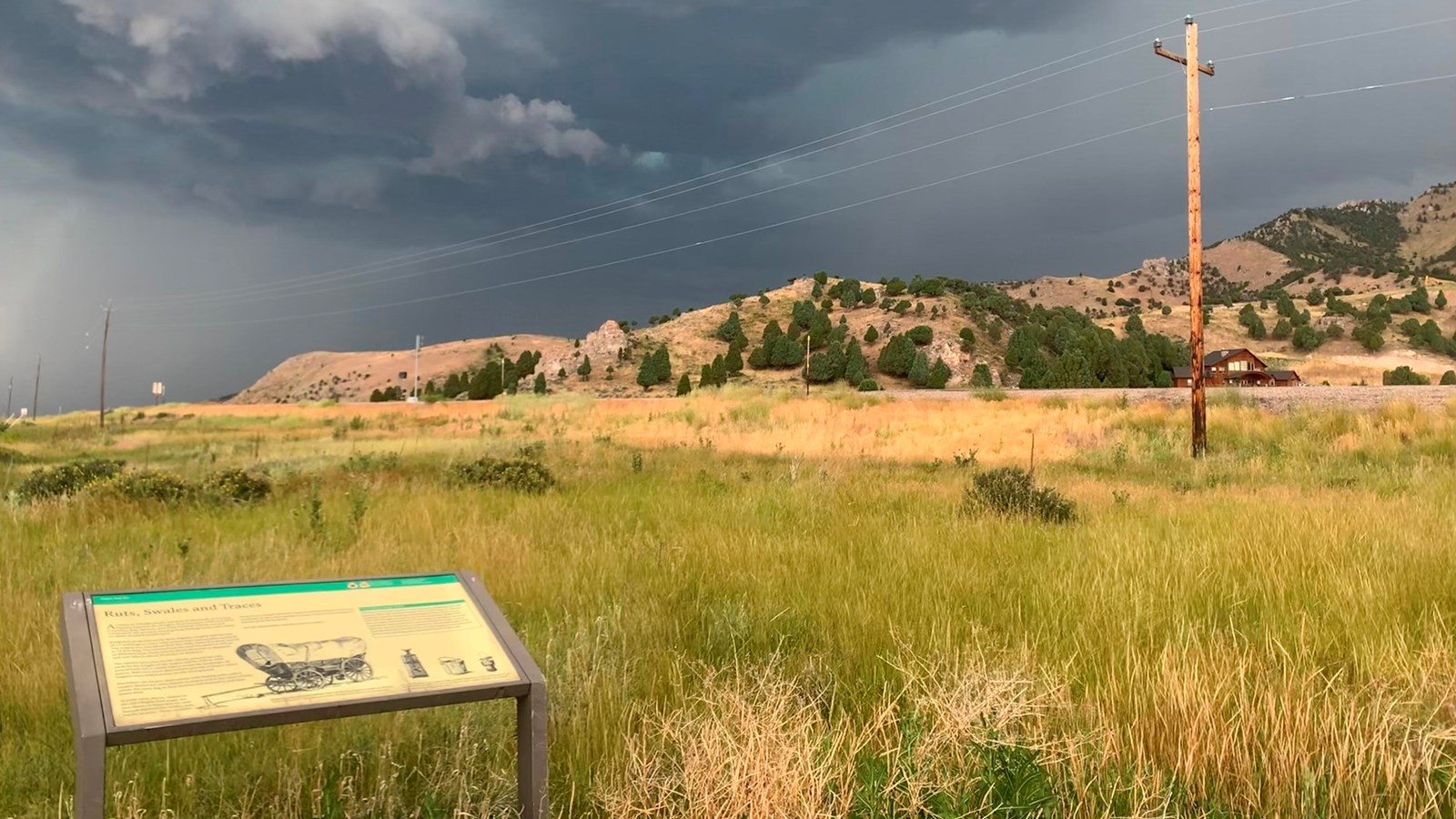 Oregon Trail Park and Marina Wayside. Visible swale in background and dark storm clouds overhead. 