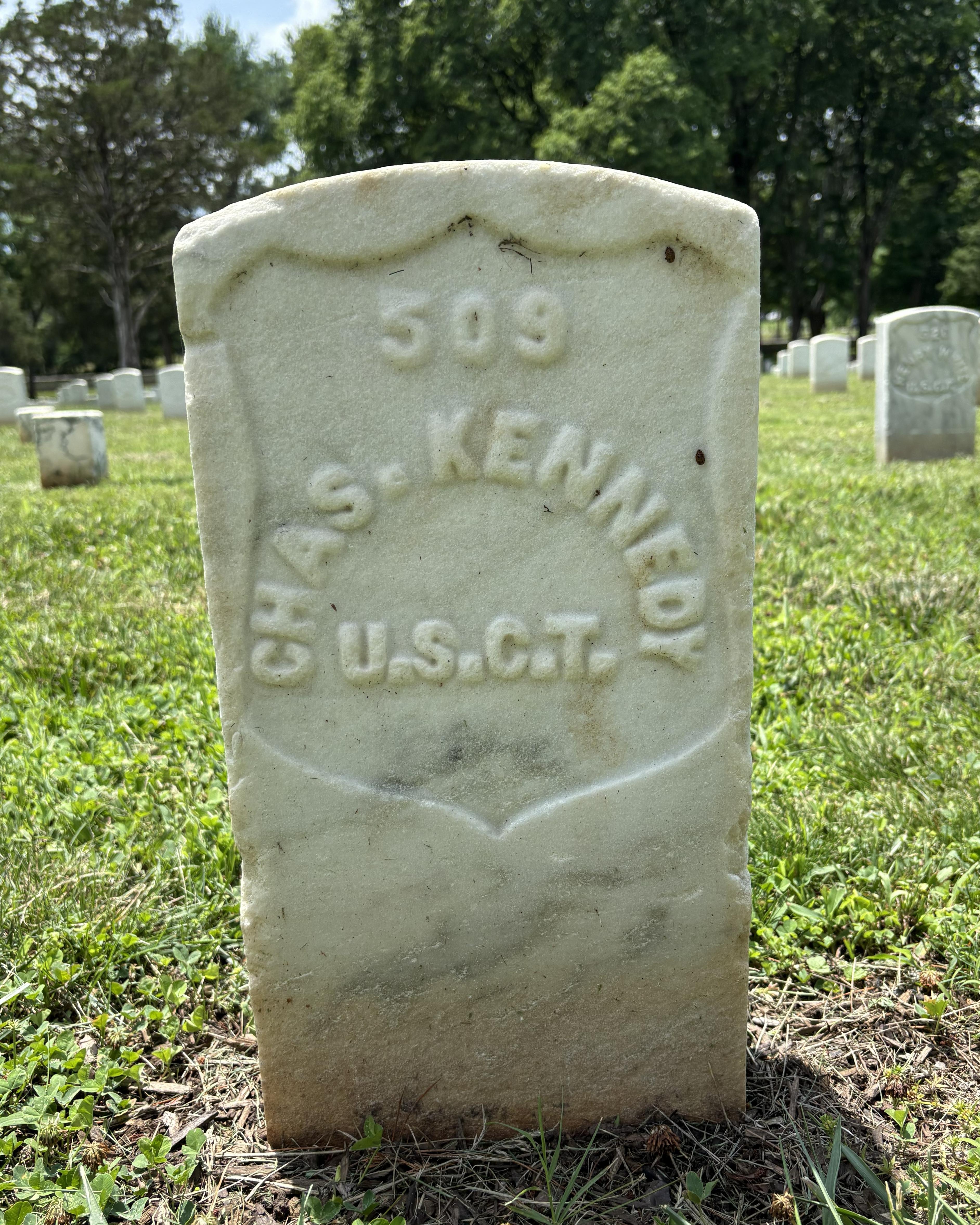 Headstone with the writing "Chas. Kennedy" on it. 