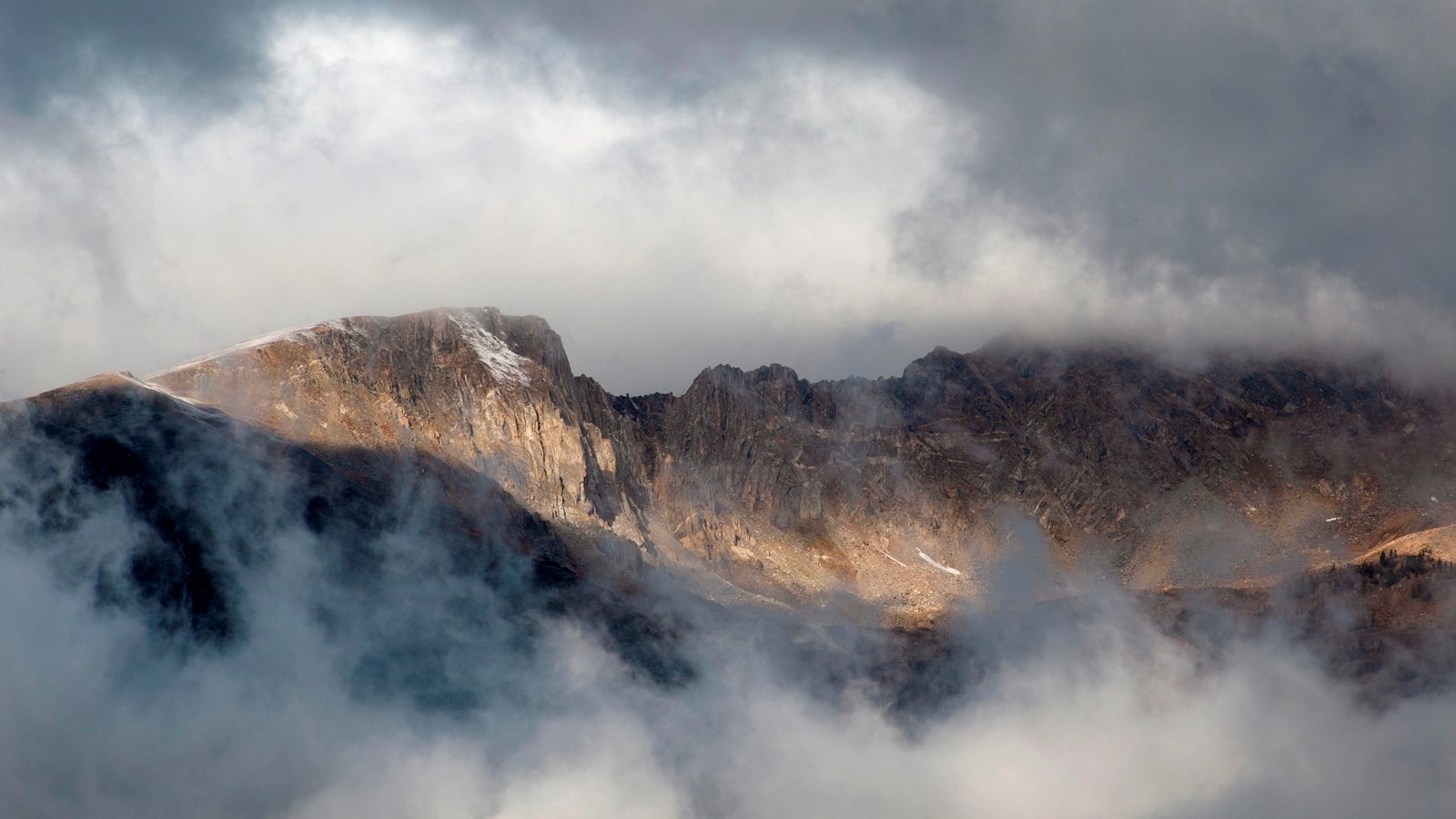 clouds frame a mountain peak