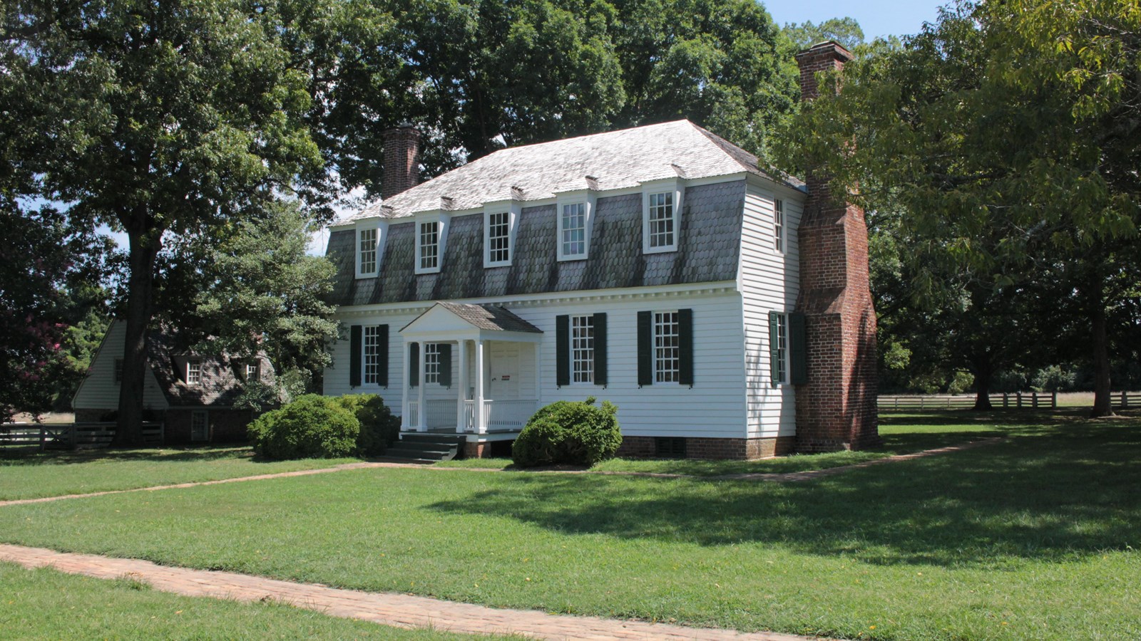 The Moore House, A white house with a white fence around it.