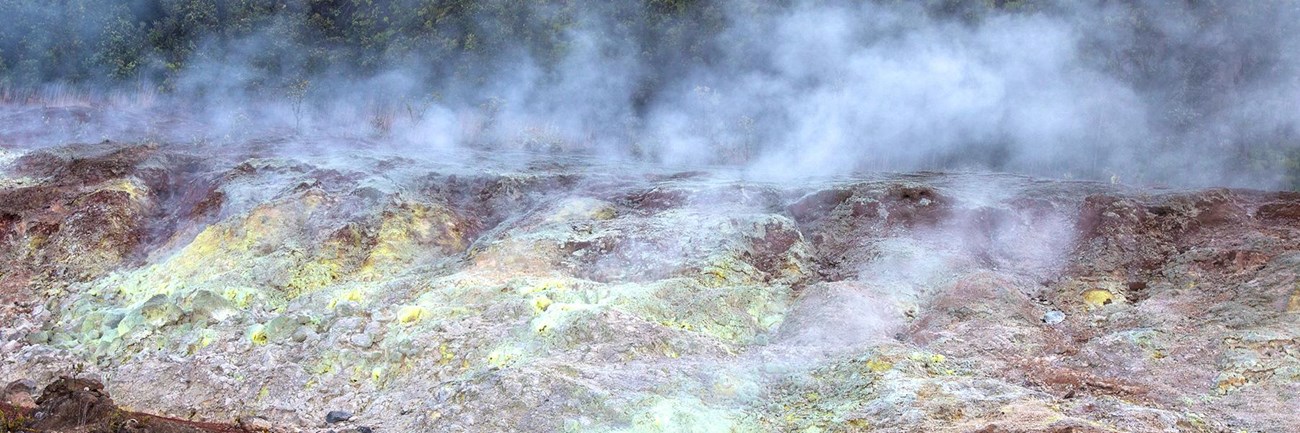 Steam rising from a colorful geothermal area