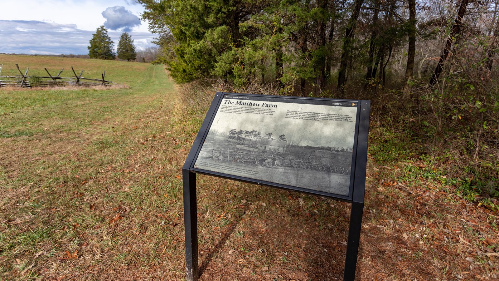 An image of the Matthew Home in 1862. A barrier fence sits in front of a farmhouse.