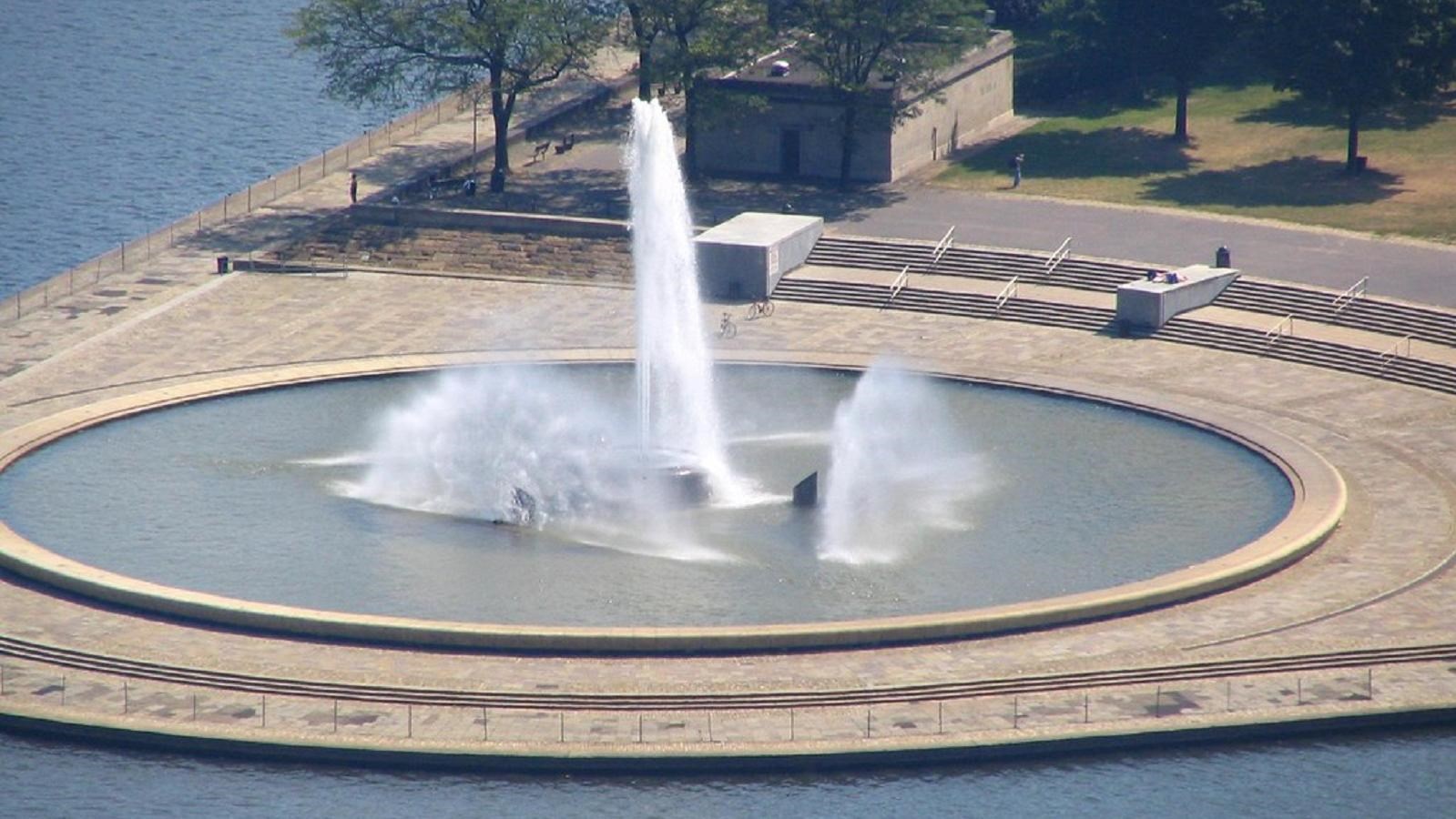 A large circular fountain sprays water into the air