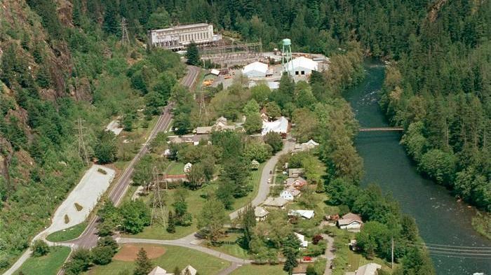 Aerial view of Newhalem, river running alongside town and buildings.
