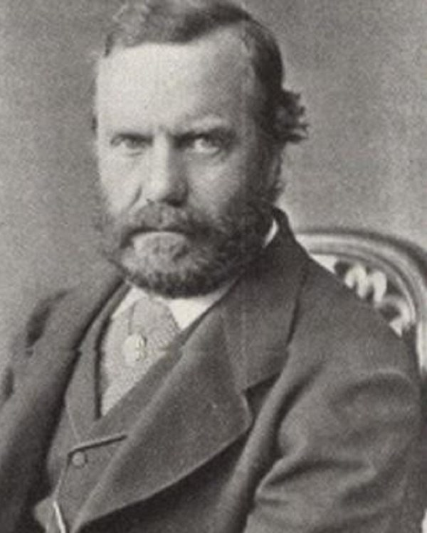 Black and white sitting portrait of Theodore Sr. gazing sternly at camera.