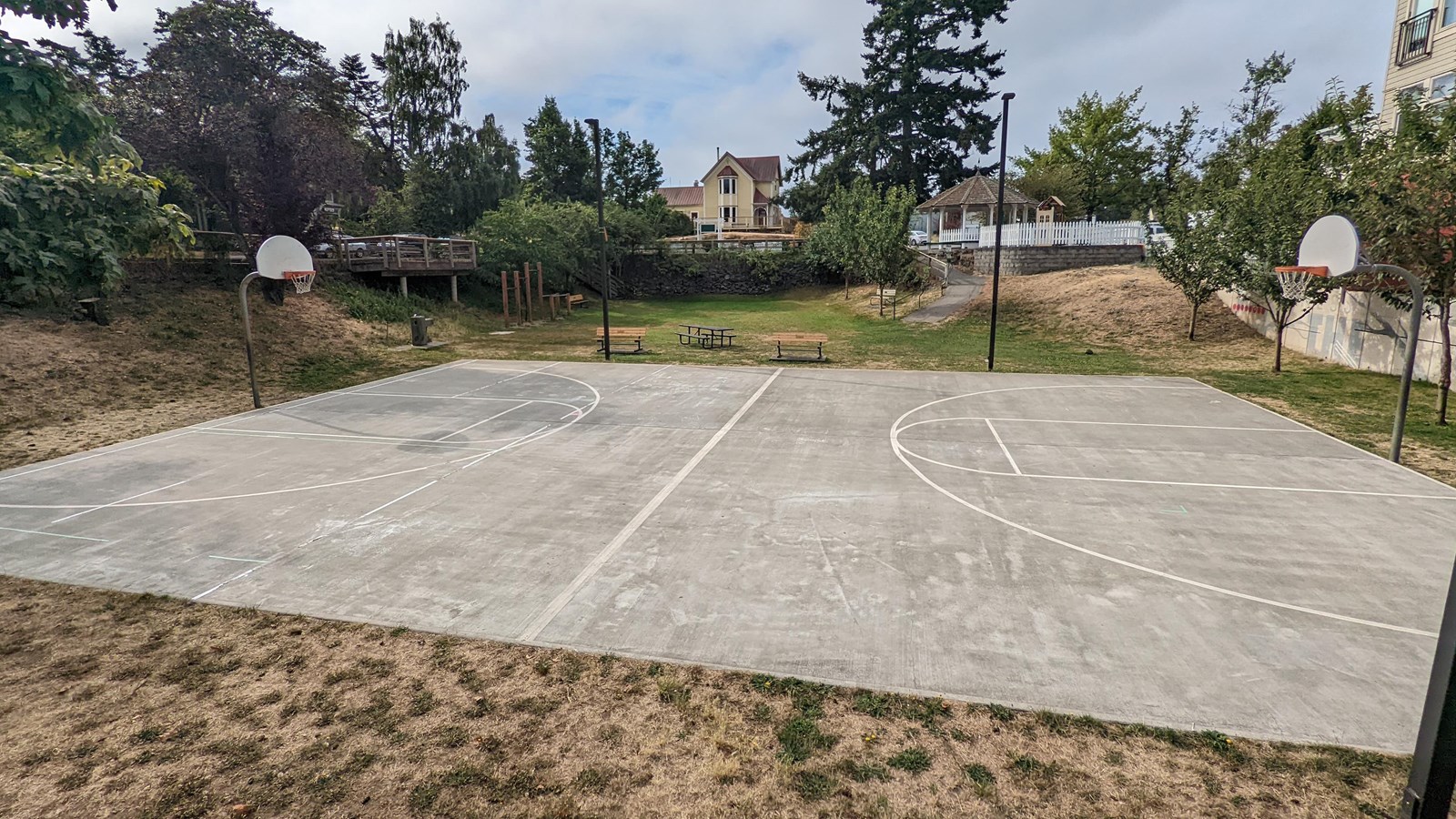 A park with a playground, gazebo, basketball court and green space