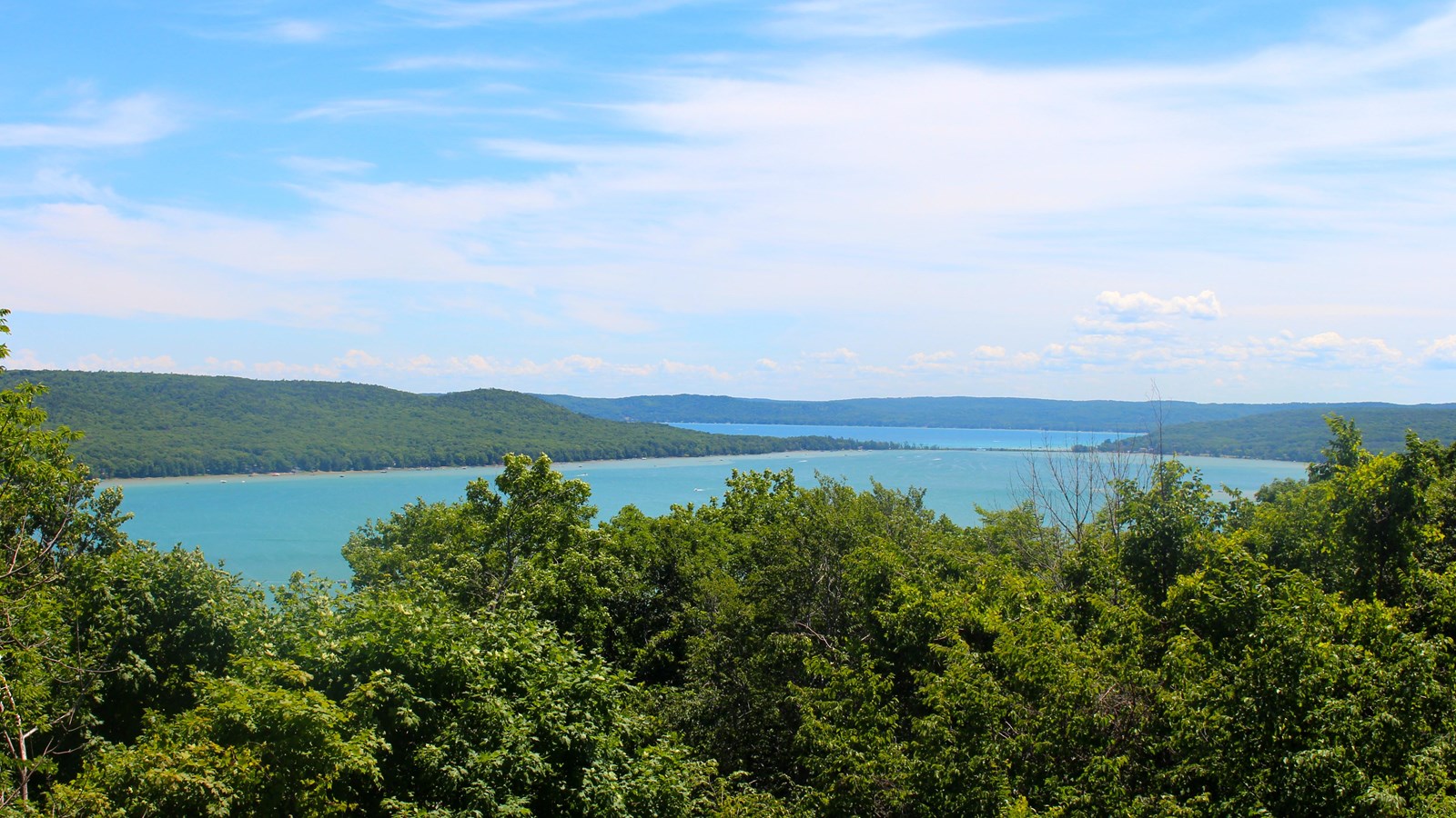 Distant view of two turquoise-watered lakes connected by a causeway