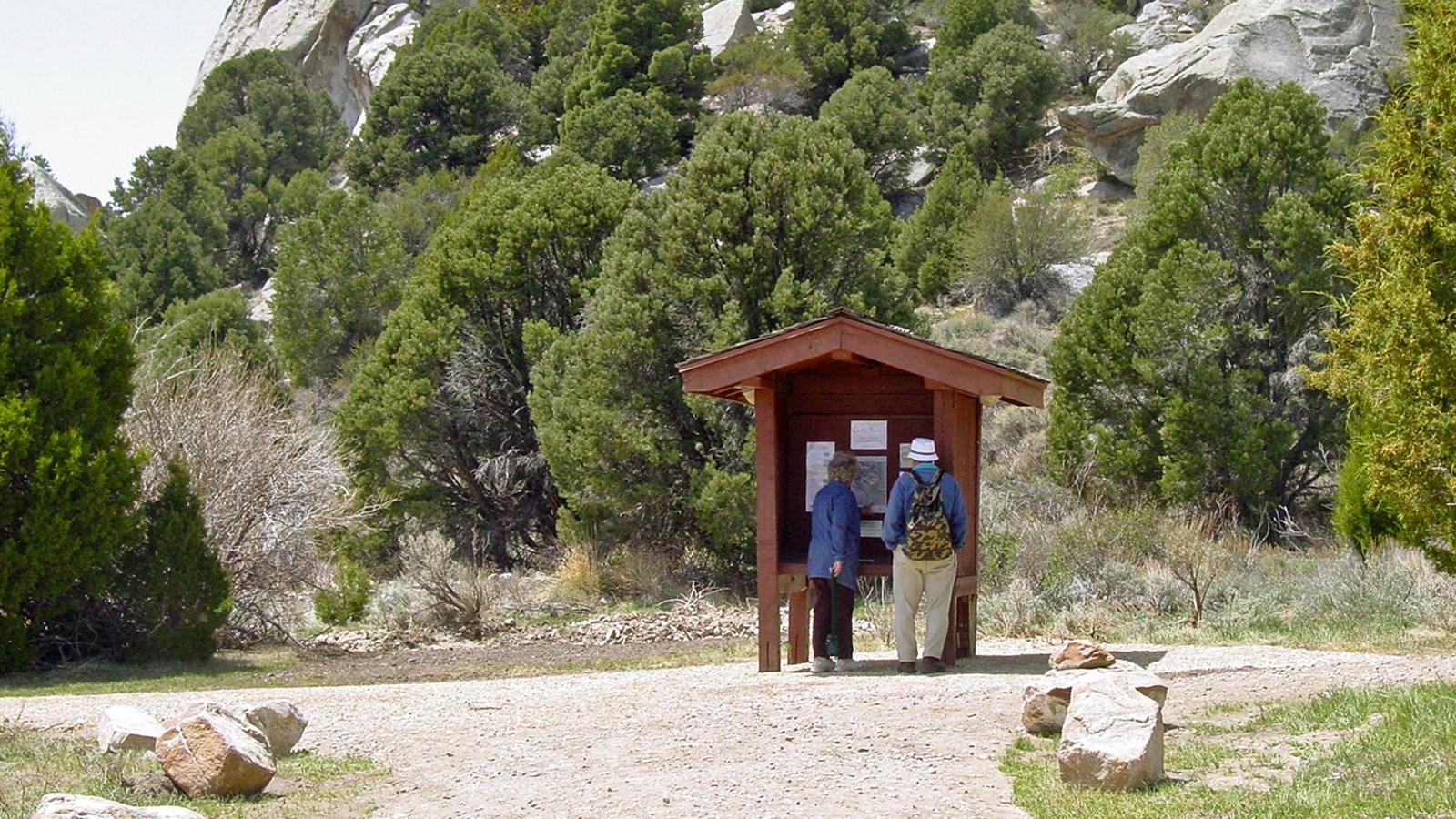 Two people looking at an information kiosk at the Stines Creek Trailhead