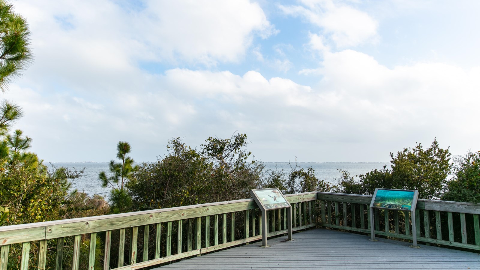 A wooden deck and benches overlook the Santa Rosa Sound.