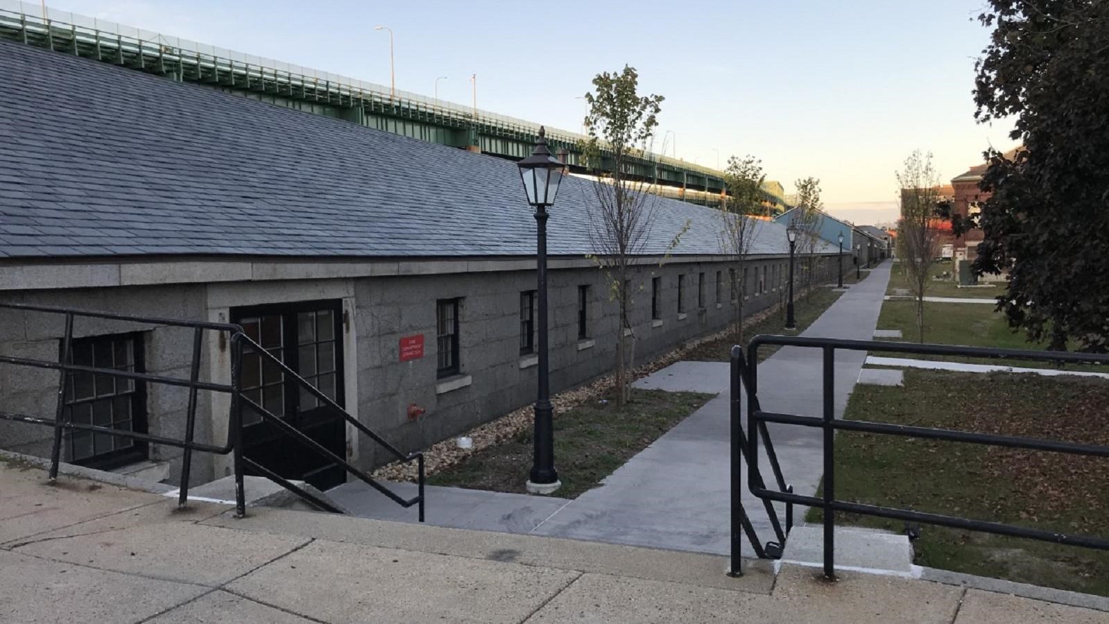 A 1/4 mile long granite stone building with square windows spaced evenly down the length of building