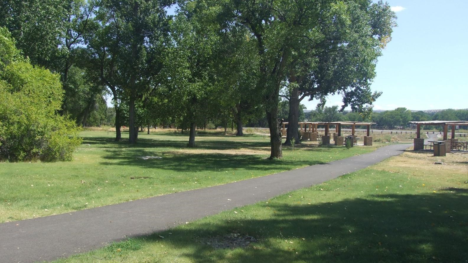 A blacktop trail through the picnic area.