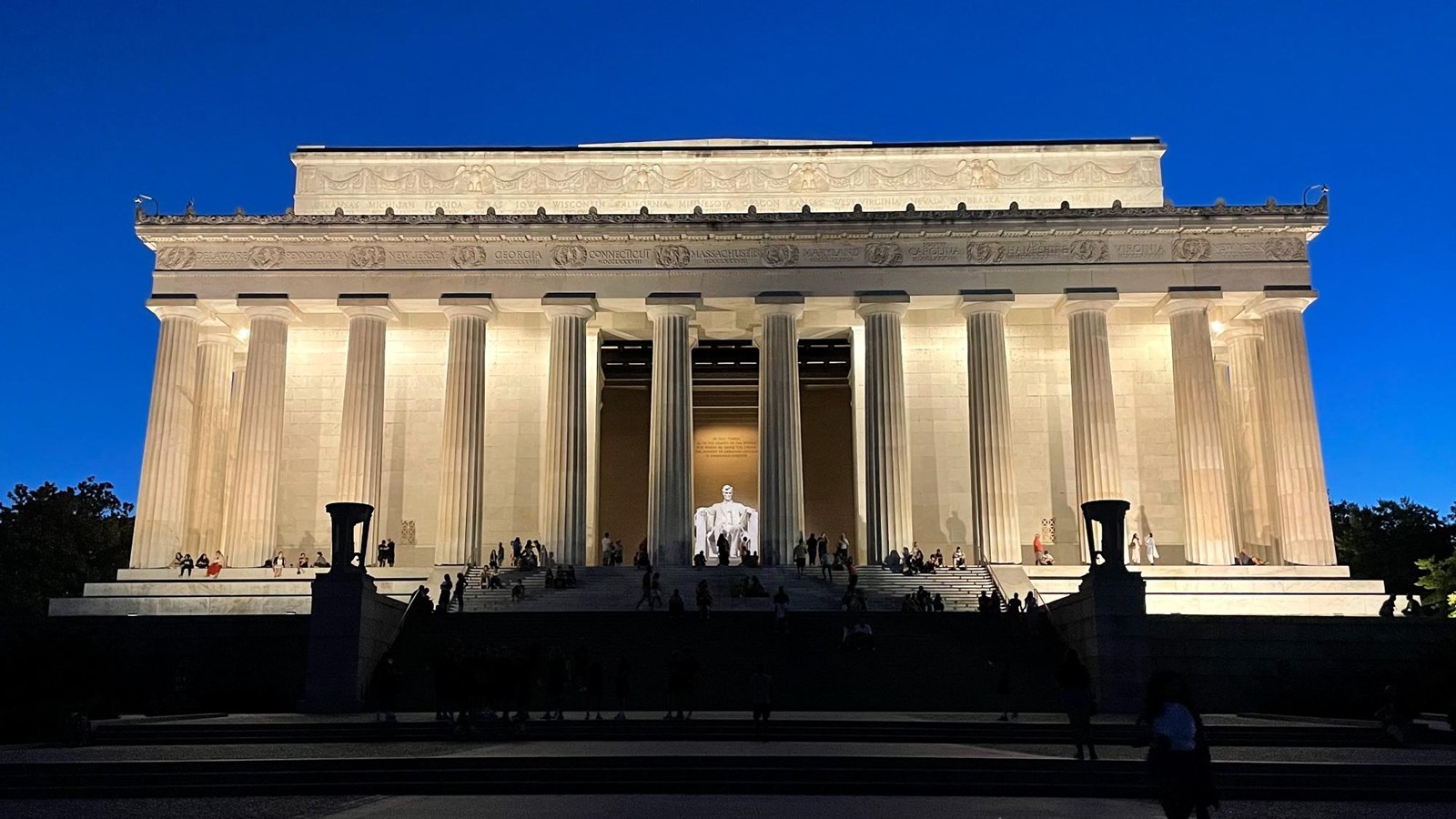 Large, white colonnaded building at dusk