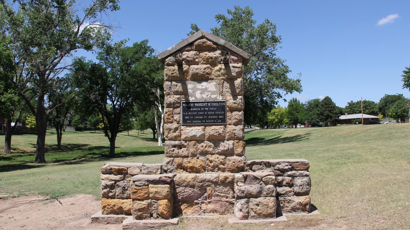 Monument in Chilton Park made of stonework with a bronze plaque.