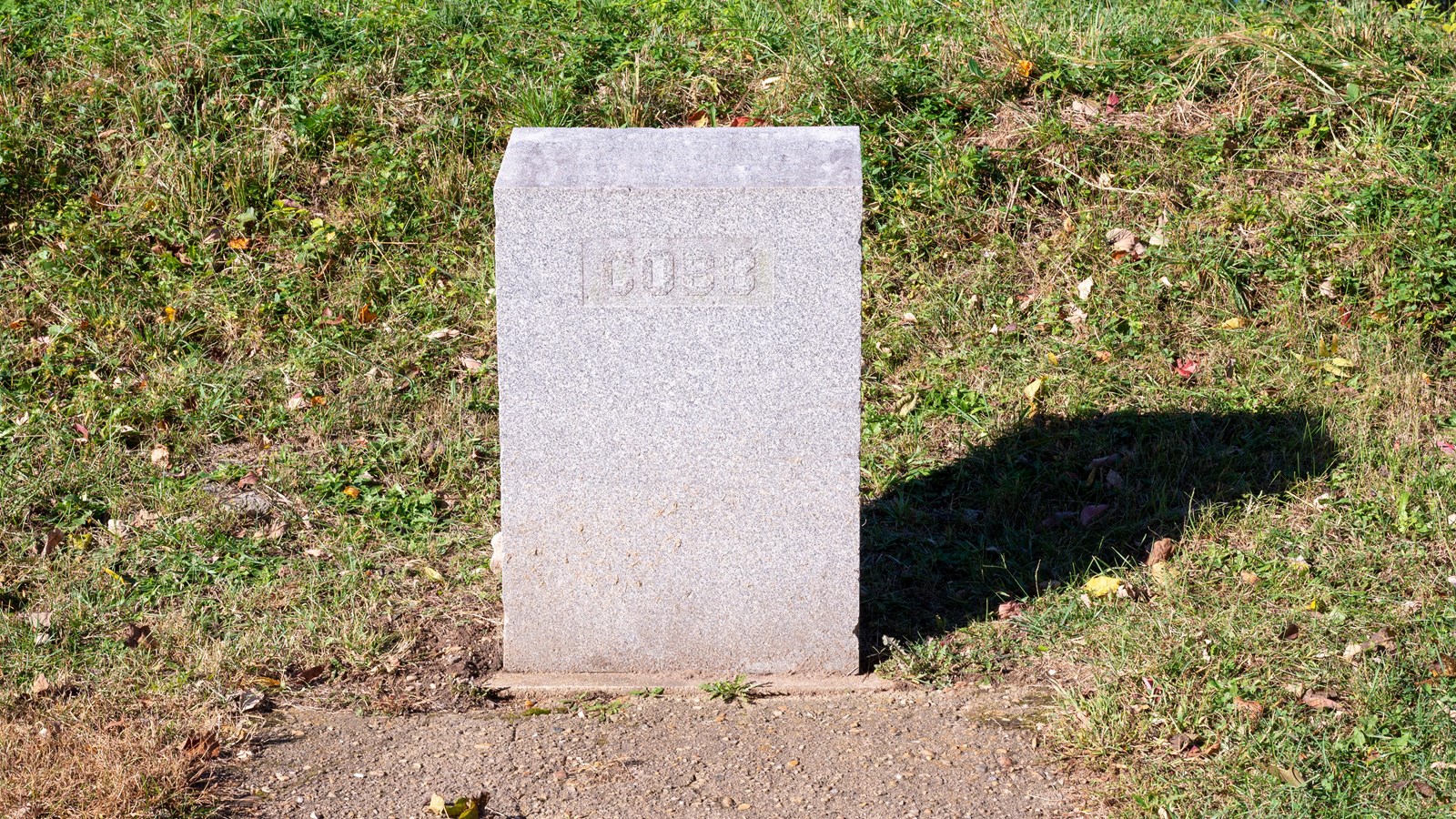 A rectangular stone memorial, 2 feet high, with the name Cobb inscribed on the stone.
