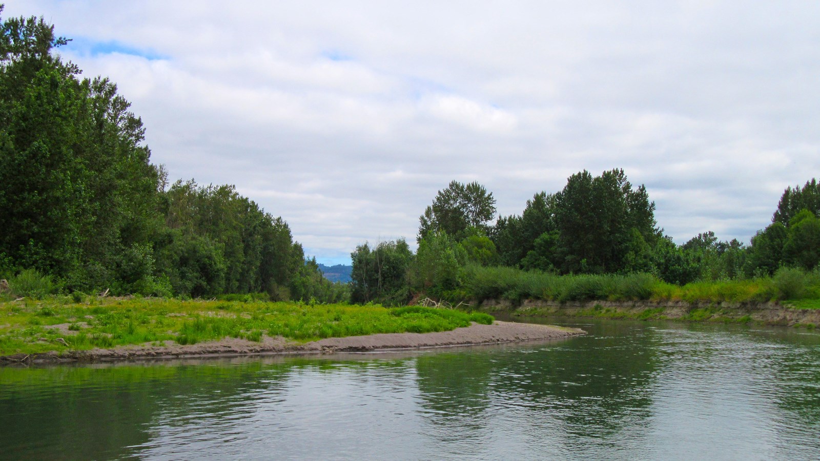 River bending with sandbar and trees on shore