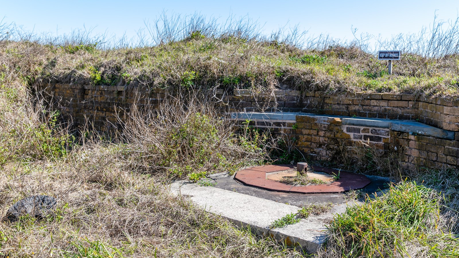 A concrete and brick installment for a Parrot rifle stands at the top of a fort.
