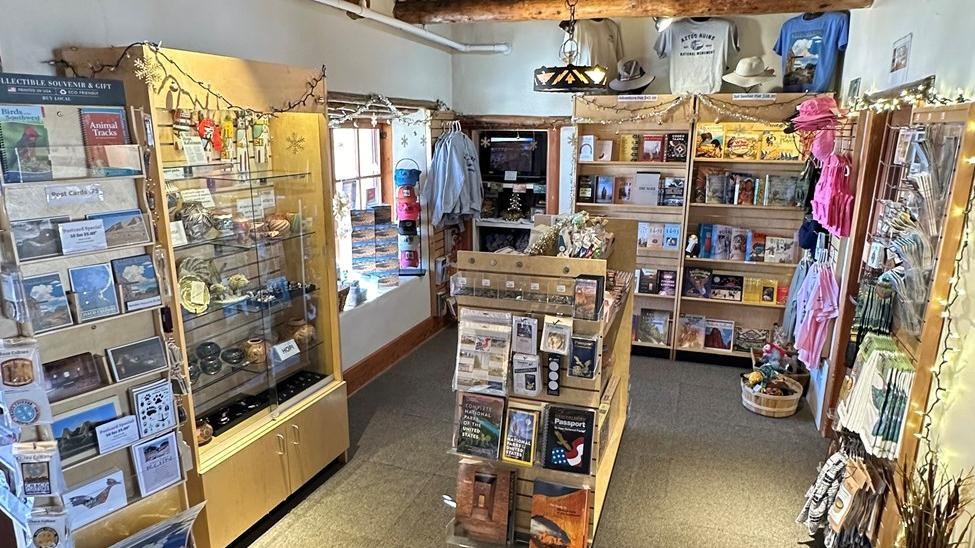 A bookstore displaying T shirts, magnets, tokens, pottery, and other park specific merchandise.