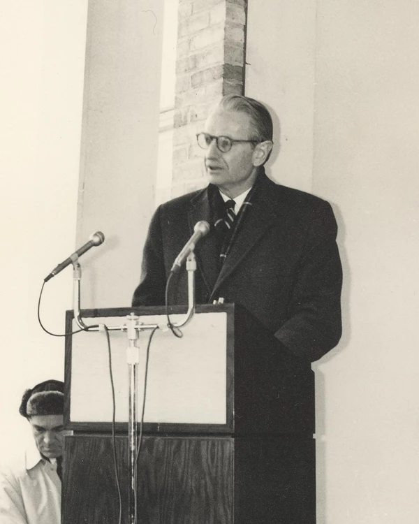 man stands at podium and delivers speech