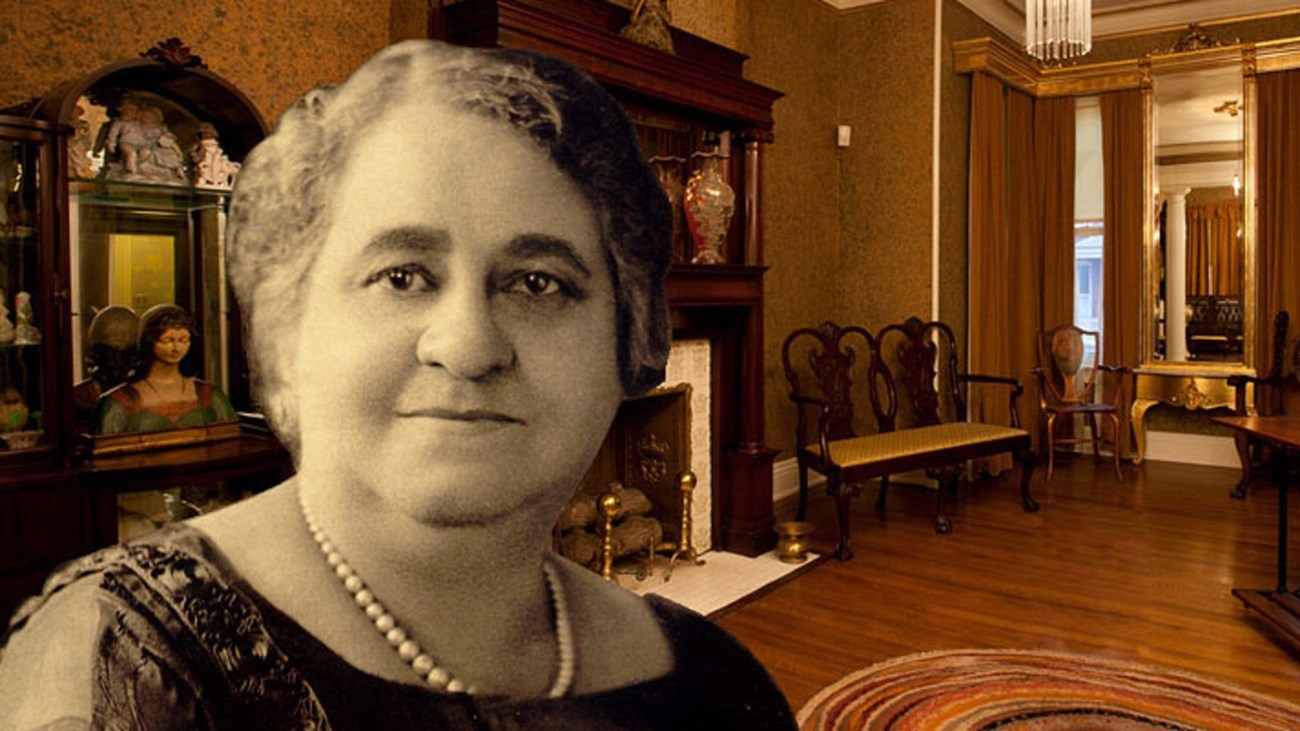 Maggie L. Walker looking forward, fireplace and chair in background