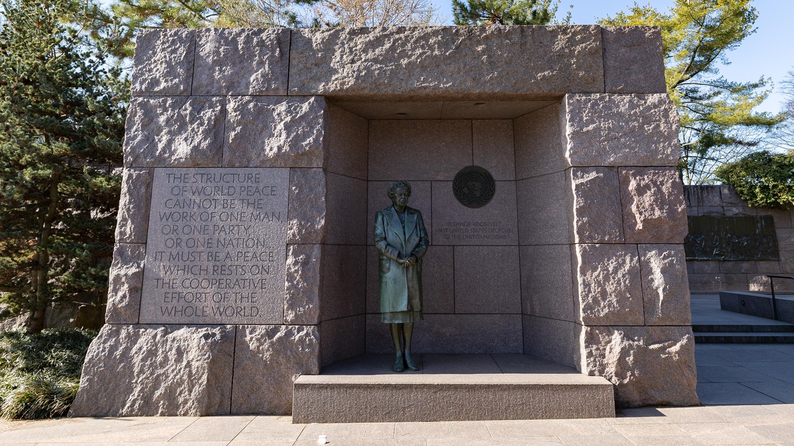 A statue of Eleanor Roosevelt is positioned in a stone opening. A quote is engraved to the left.