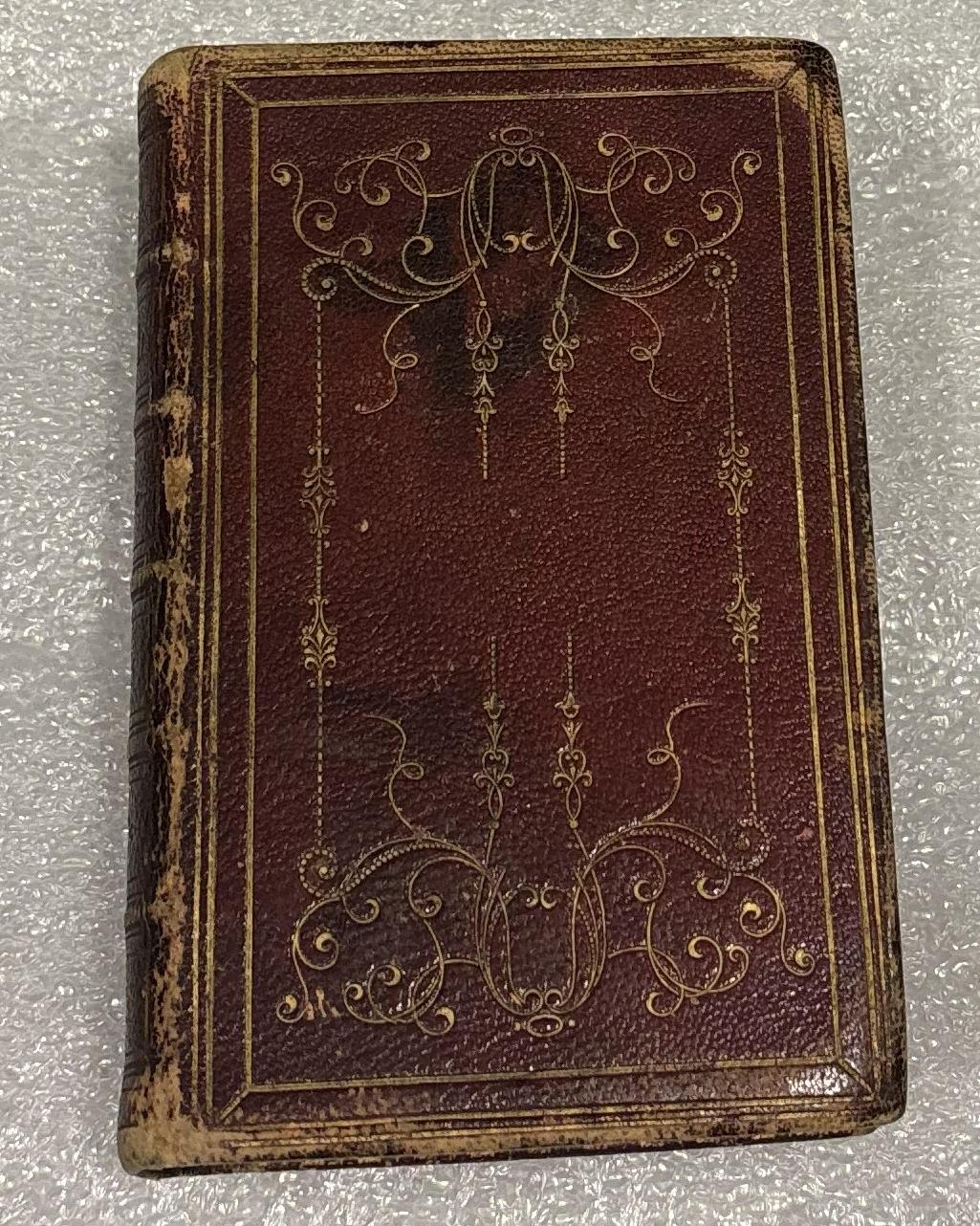 Red leather bible with ornate gold foil edges. 