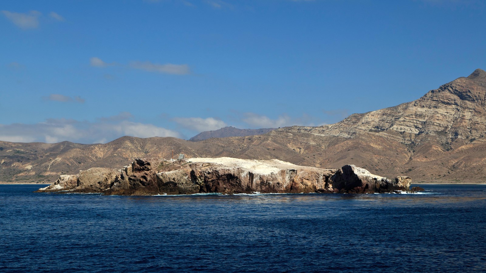 small flat rocky islet in ocean
