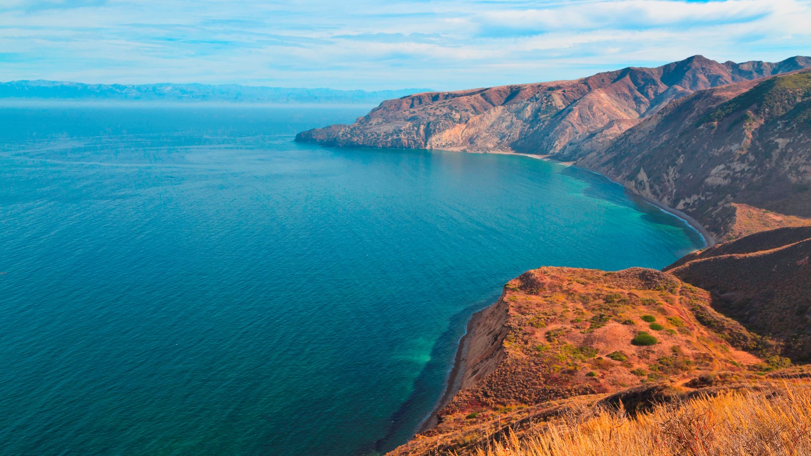 Large harbor on the northern side of Santa Cruz Island that is surrounded by steep hillsides. An ol