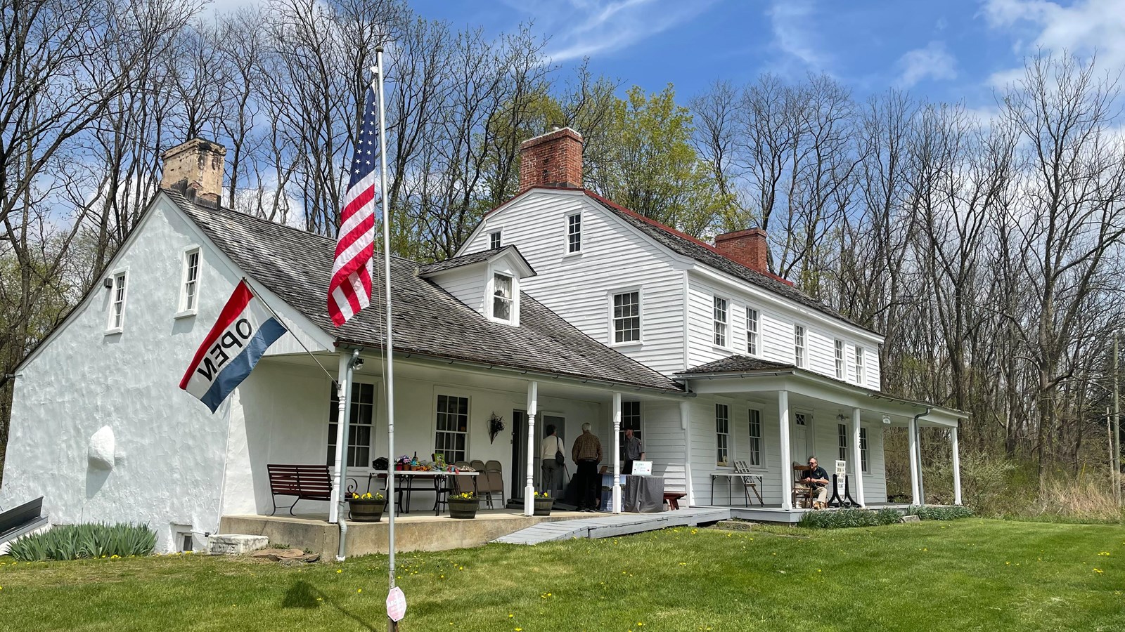 A white house with a green lawn.