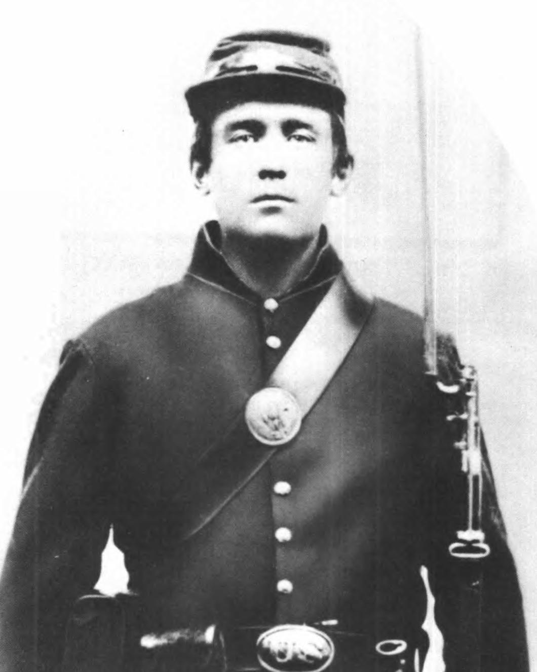 A US Civil War soldier poses for a photograph in uniform. 