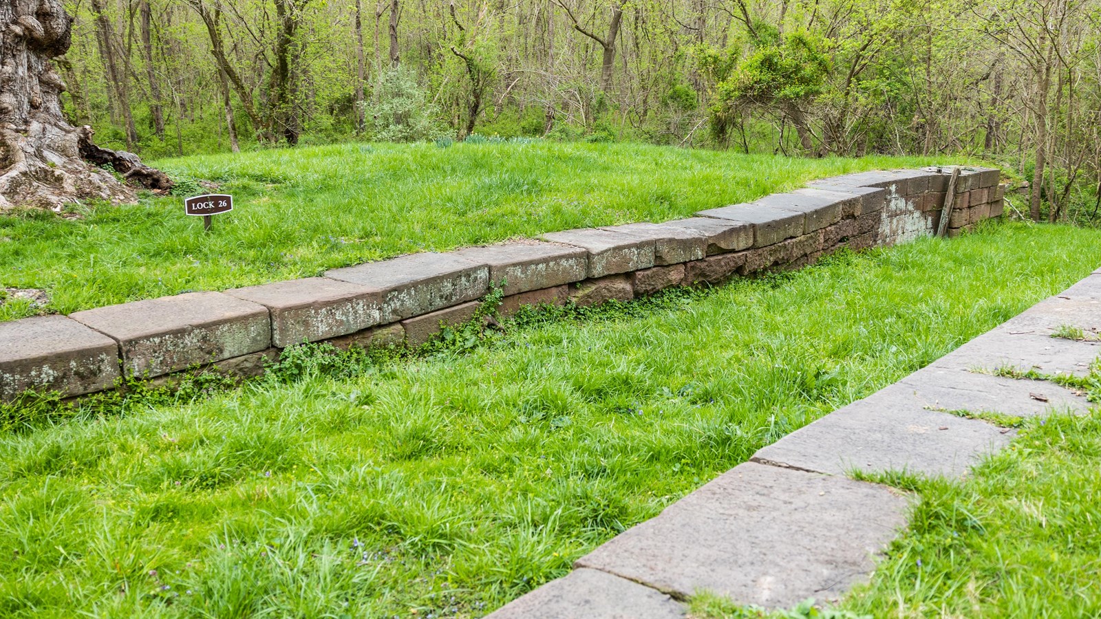 An historic stone lock filled in with dirt