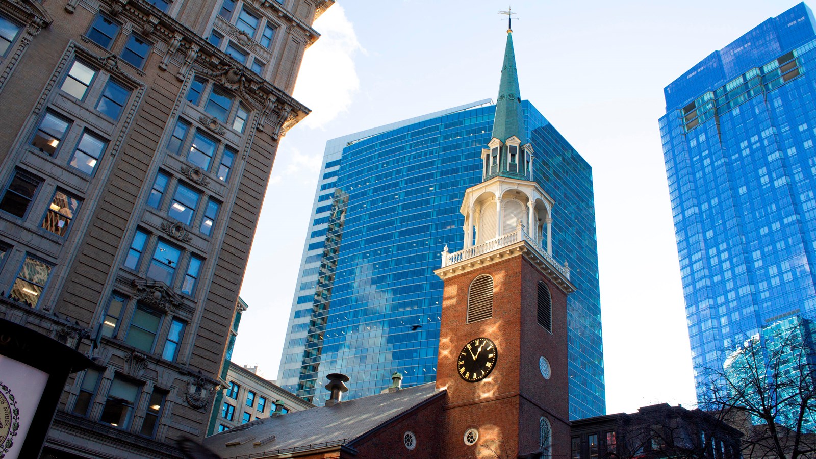 Photo looking up at the tall brick and copper steeple of Old South Meeting House