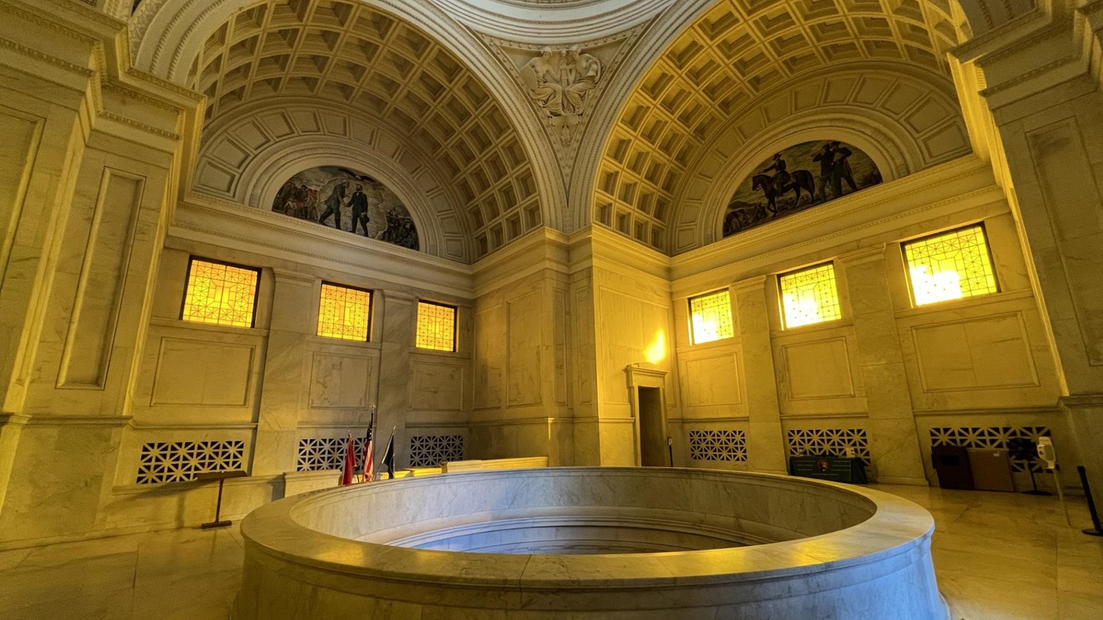 A rotunda filled with golden light. There are mosaics on the upper walls.
