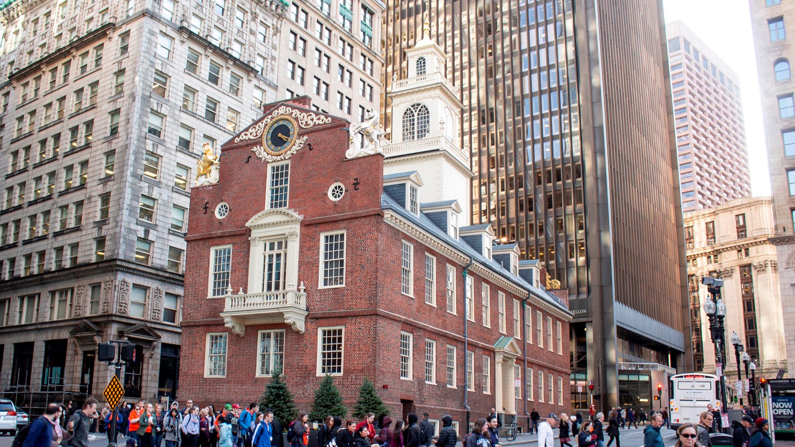 The red brick Old State House with a clock, balcony, and lion and unicorn figures.