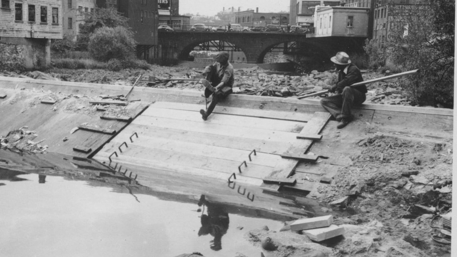 Workers repairing the Slater Mill Dam