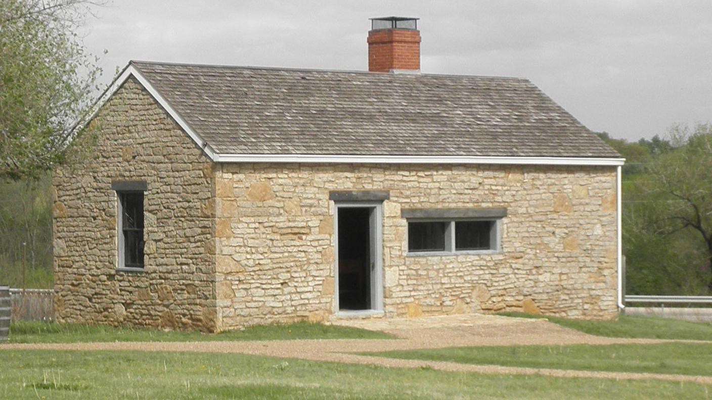 one story stone building with chimney