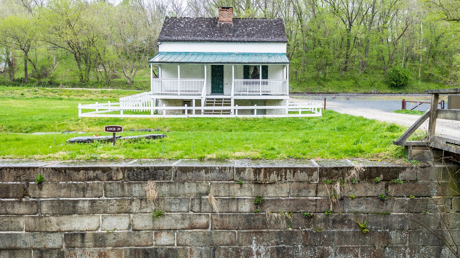 An historic stone lock in front of a lockhouse