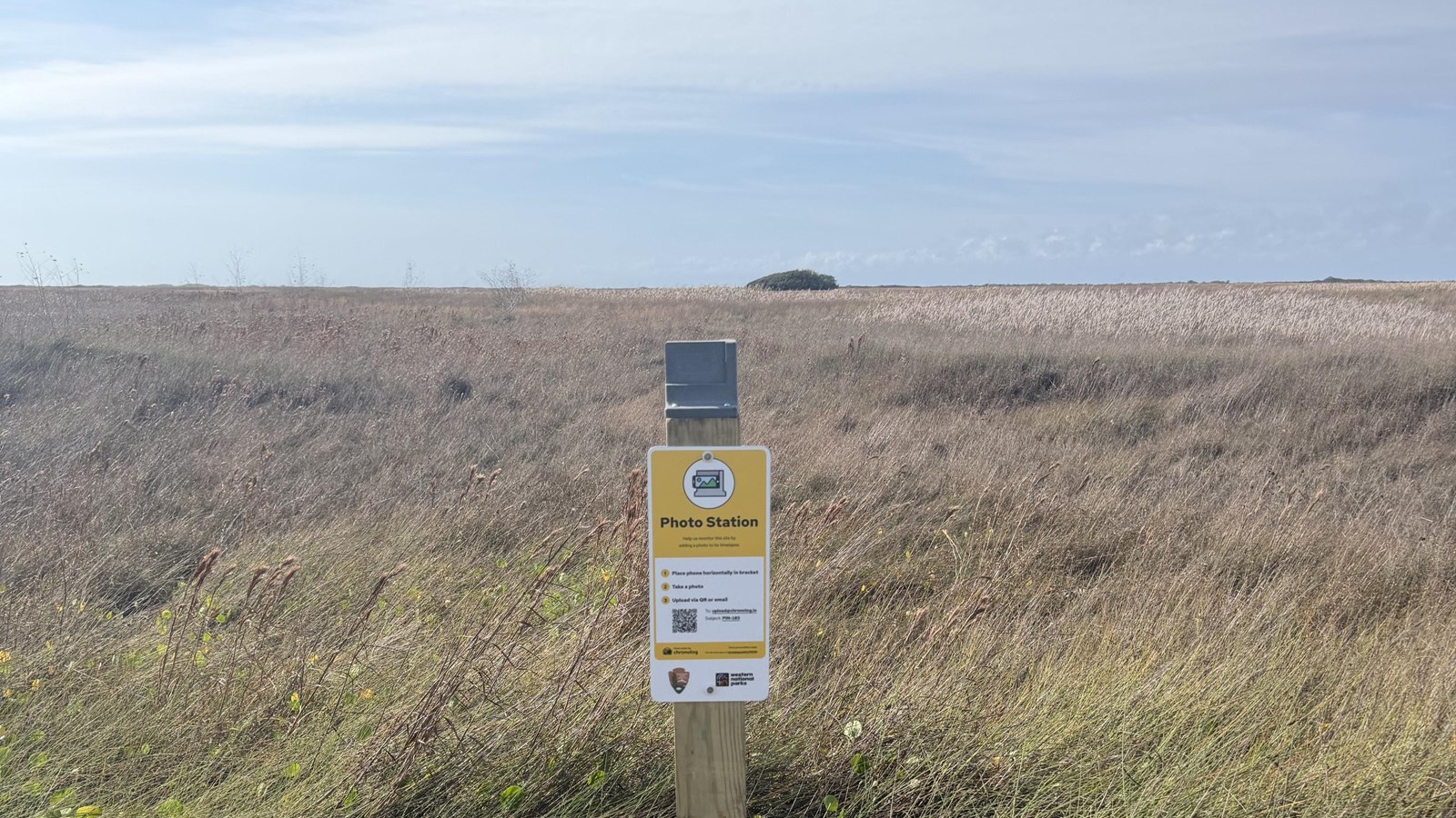 A photo monitoring station attached to a wooden post. 