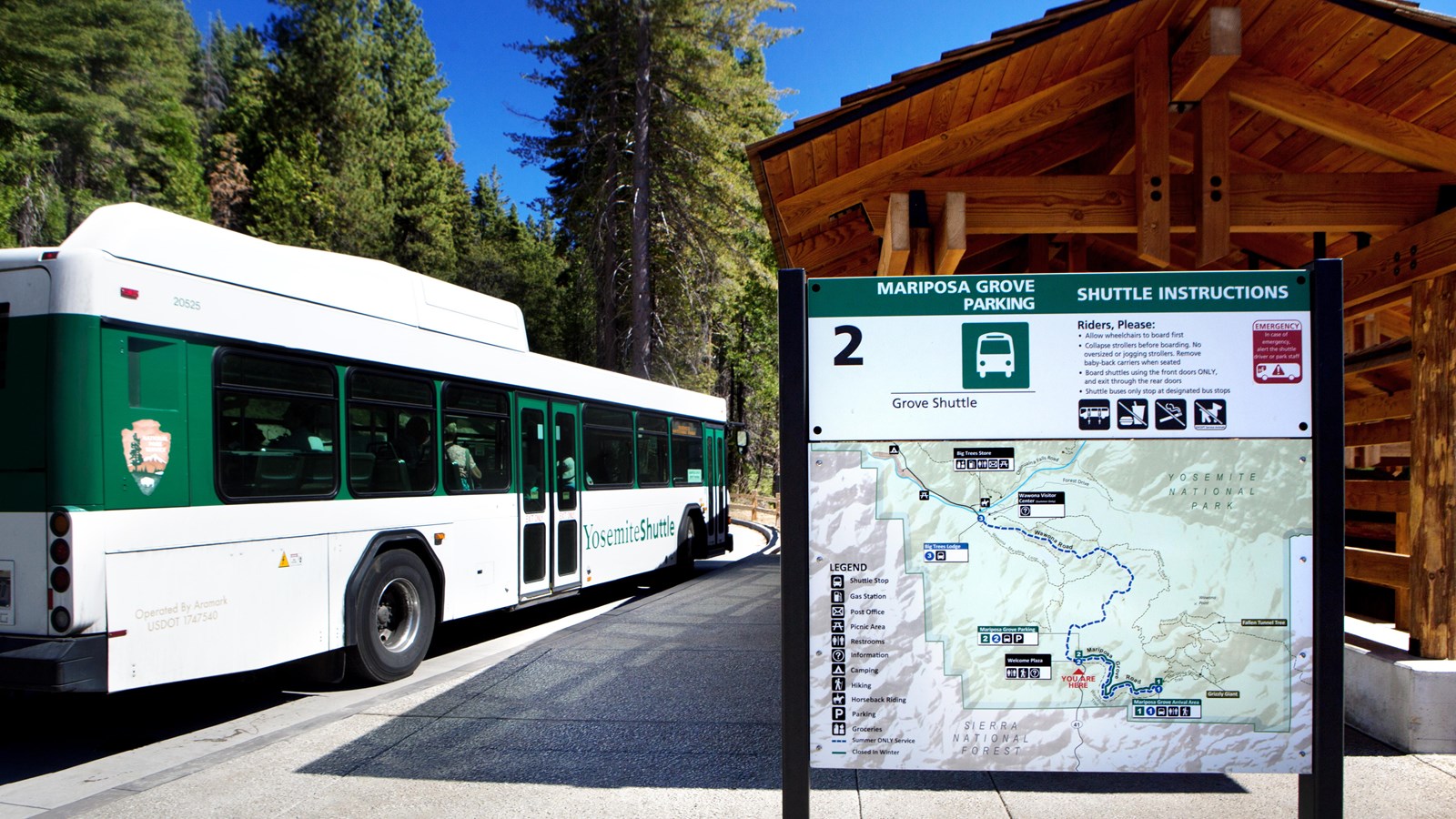 Shuttle bus near stop with map displayed nearby
