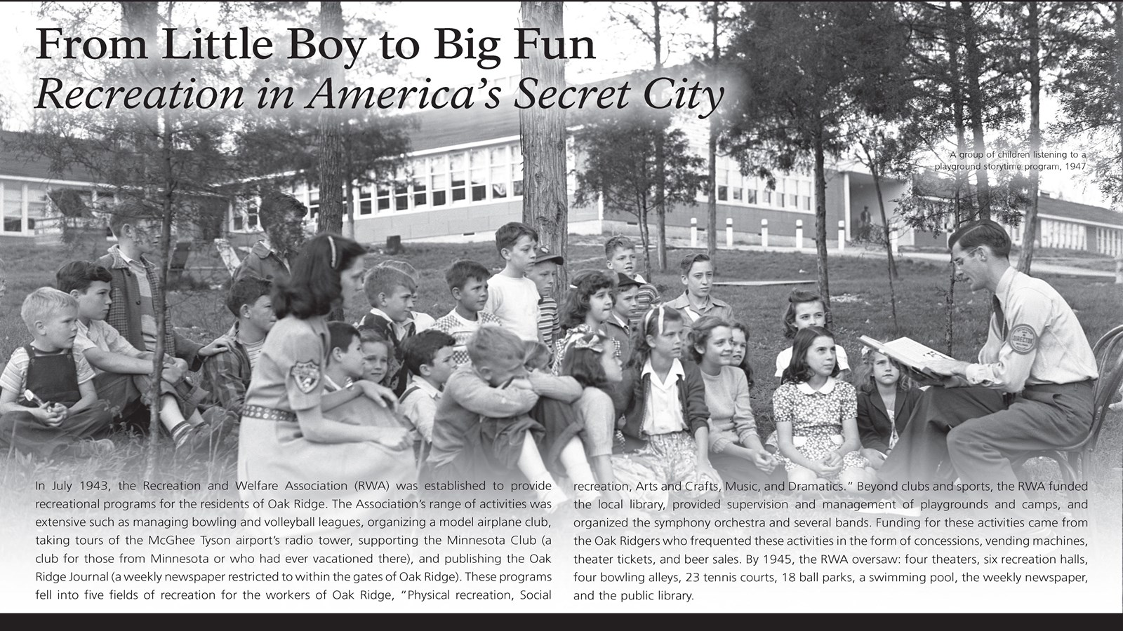 A wayside exhibit with text and an image of several children being read to in front of a school.