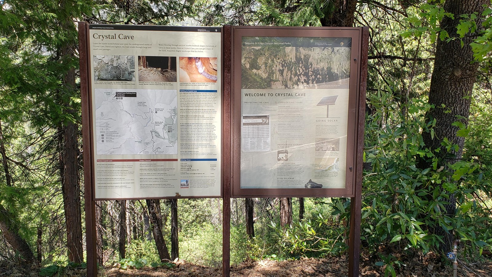 Two upright panels provide Crystal Cave trail orientation and historical information.