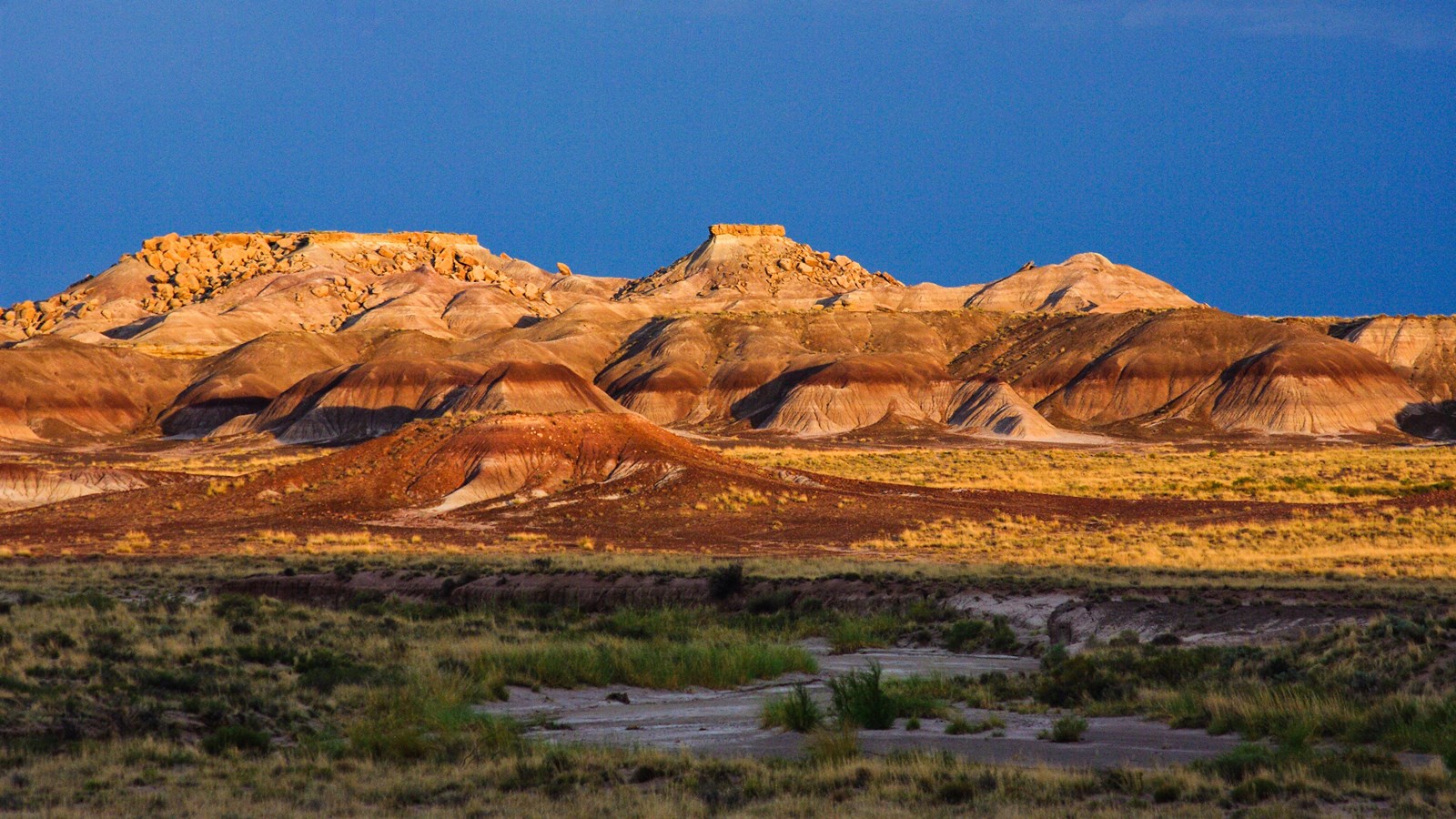 Badlands lit up against a twilight sky.