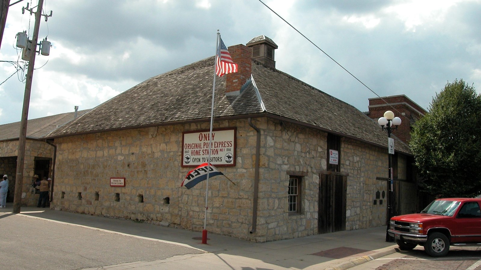 A stone, one-story building, with a wooden front door and no windows.