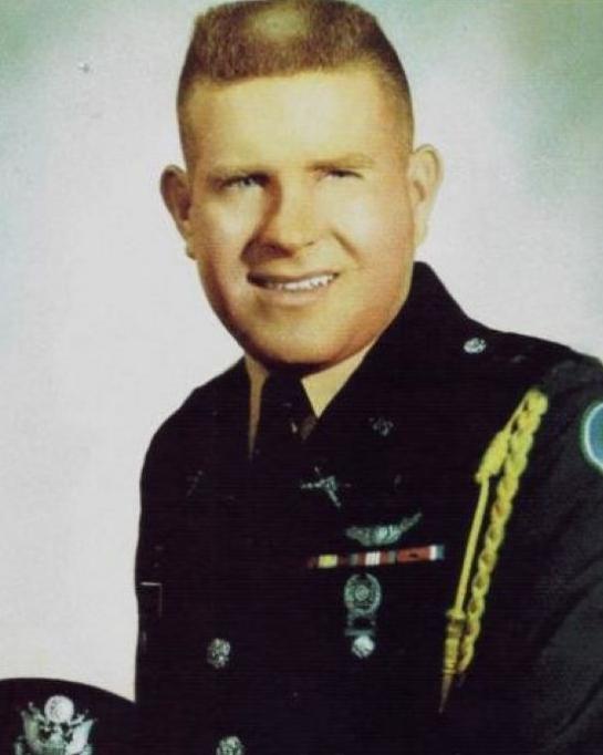 Young man wearing USAF military dress uniform and smiling for photo. 
