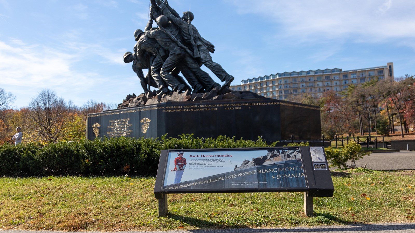 A photograph of a Marine standing on the Marine Corps Memorial is displayed on the information panel