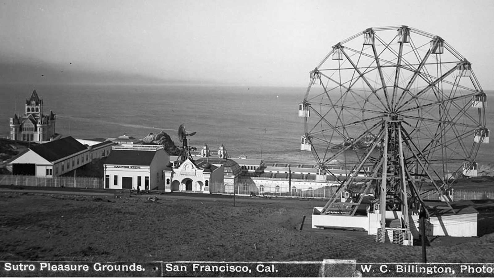 The ferris wheel and other attractions at Merrie Way with Cliff House and the Baths in the back.